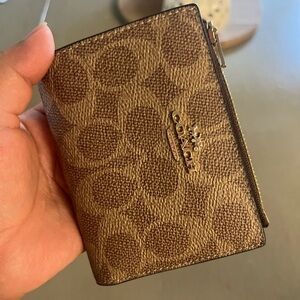 Coach bifold wallet in signature canvas
